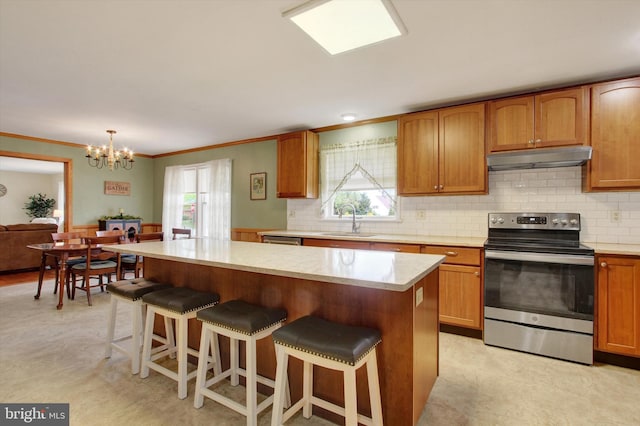 401 Jacobs St, East Berlin, PA 17316 - kitchen featuring stainless steel appliances, under cabinet range hood, a chandelier, a kitchen bar, and a kitchen island