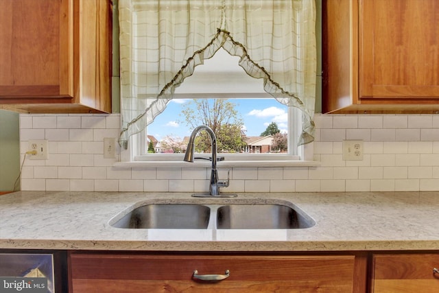 401 Jacobs St, East Berlin, PA 17316 - kitchen with brown cabinetry, light stone counters, backsplash, and healthy amount of natural light