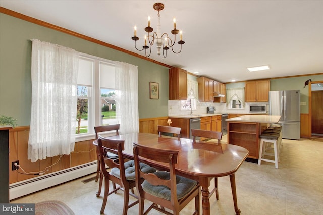 401 Jacobs St, East Berlin, PA 17316 - dining area with a baseboard heating unit, a chandelier, ornamental molding, a wainscoted wall, and wood walls
