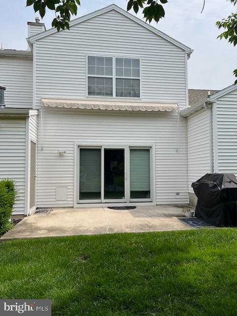 621 Springhouse Ln, Hummelstown, PA 17036 - rear view of house with a yard, a patio area, and a chimney