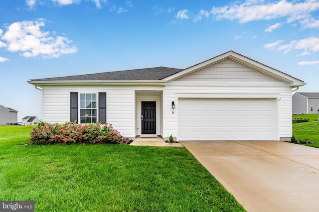 9 American Ave, Carlisle, PA 17013 - single story home with a front lawn, driveway, a garage, and a shingled roof