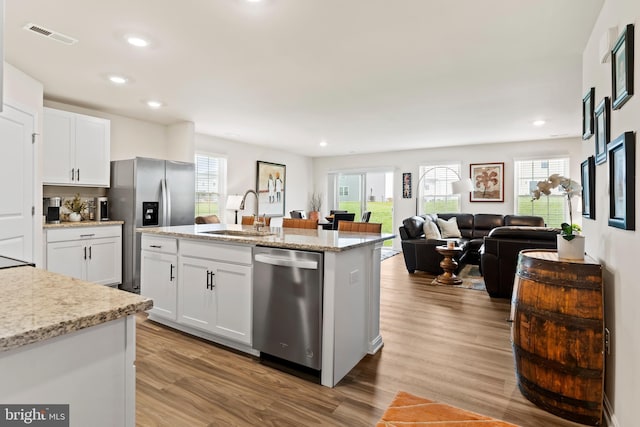 9 American Ave, Carlisle, PA 17013 - kitchen with appliances with stainless steel finishes, wood finished floors, white cabinets, recessed lighting, and open floor plan