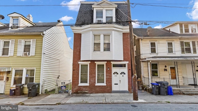 312 N 2nd St, Steelton, PA 17113 - multi unit property with brick siding, covered porch, mansard roof, and roof with shingles