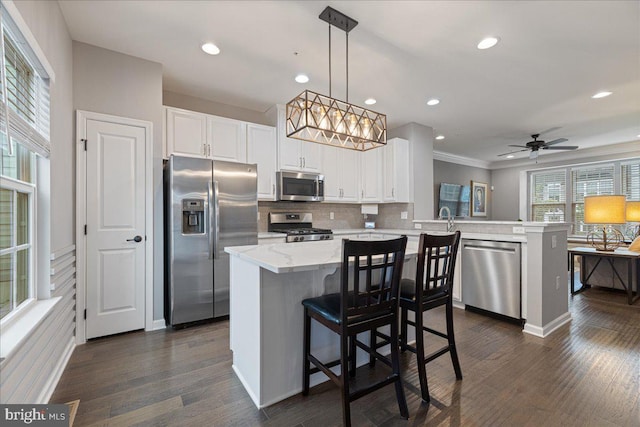 260 Grace Ln, Harleysville, PA 19438 - kitchen with stainless steel appliances, a peninsula, dark wood finished floors, backsplash, and white cabinets