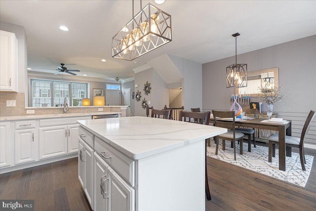 260 Grace Ln, Harleysville, PA 19438 - kitchen with a chandelier, a kitchen island, dark wood-type flooring, a ceiling fan, and white cabinets