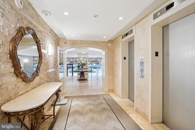 8370 Greensboro Dr Unit 1011, Mclean, VA 22102 - hall with elevator, recessed lighting, tile walls, and arched walkways