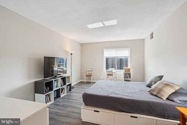 8370 Greensboro Dr Unit 1011, Mclean, VA 22102 - bedroom with wood finished floors and a textured ceiling