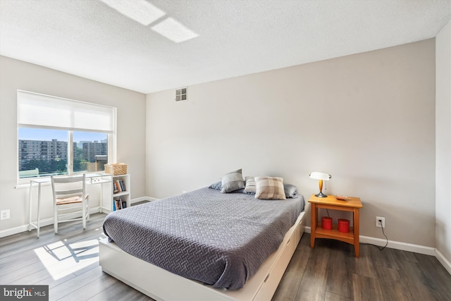 8370 Greensboro Dr Unit 1011, Mclean, VA 22102 - bedroom with wood finished floors, a view of city, and a textured ceiling