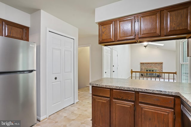 15108 Plum Tree Way, Bowie, MD 20721 - kitchen with appliances with stainless steel finishes, light countertops, a fireplace, and light flooring