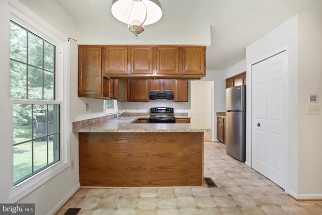 15108 Plum Tree Way, Bowie, MD 20721 - kitchen with freestanding refrigerator, black electric range oven, light flooring, brown cabinets, and extractor fan