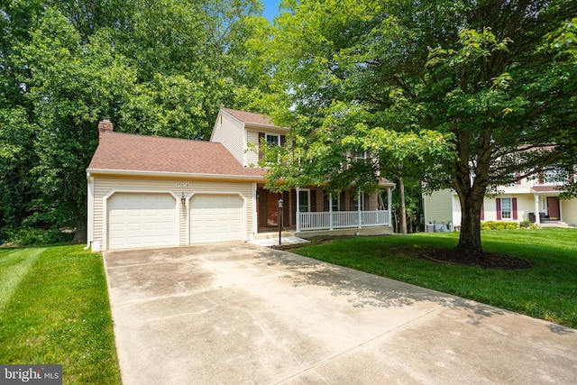 15108 Plum Tree Way, Bowie, MD 20721 - view of property hidden behind natural elements featuring a porch, a garage, a front lawn, concrete driveway, and a chimney