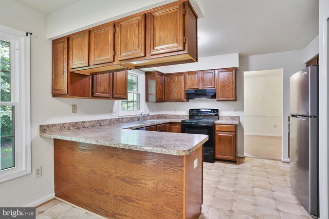 15108 Plum Tree Way, Bowie, MD 20721 - kitchen with electric range, freestanding refrigerator, range hood, a peninsula, and brown cabinets