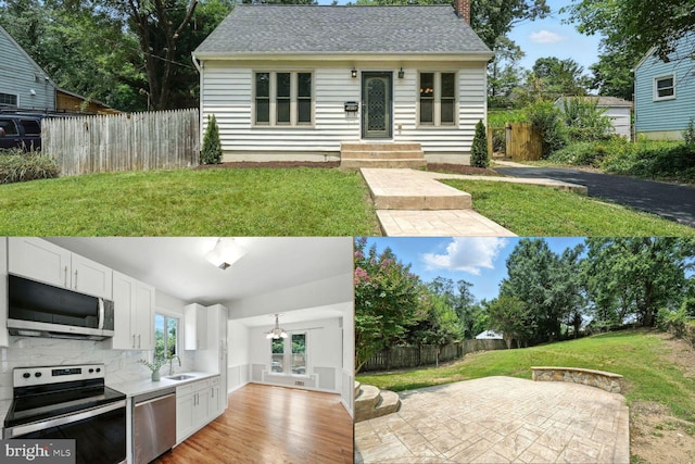 1418 D St, Woodbridge, VA 22191 - kitchen featuring stainless steel appliances, backsplash, white cabinets, wood finished floors, and a chandelier