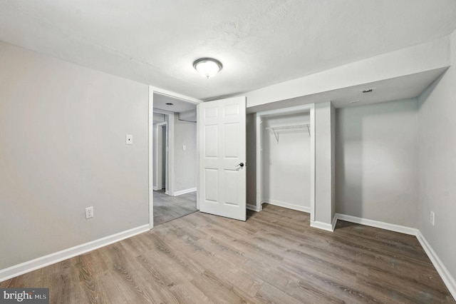 1418 D St, Woodbridge, VA 22191 - unfurnished bedroom with wood finished floors and a closet