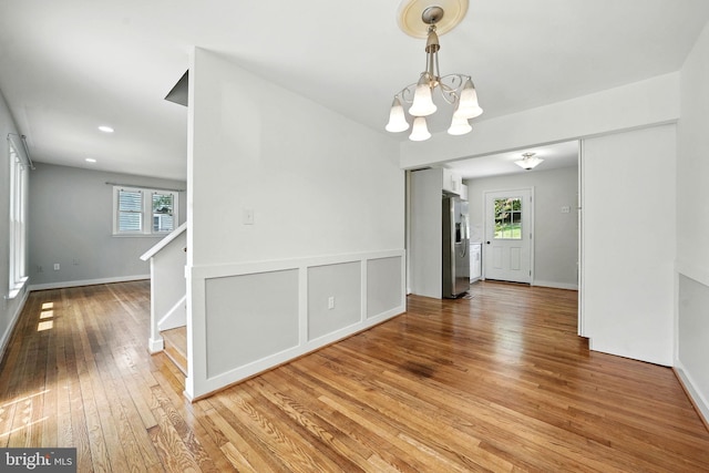 1418 D St, Woodbridge, VA 22191 - empty room featuring a chandelier, hardwood / wood-style flooring, healthy amount of natural light, and stairs