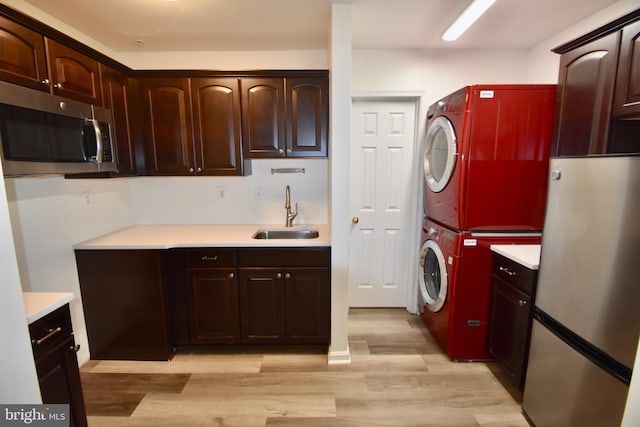 104 Rock Creek Ct, Frederick, MD 21702 - washroom featuring stacked washing machine and dryer and light wood-style floors