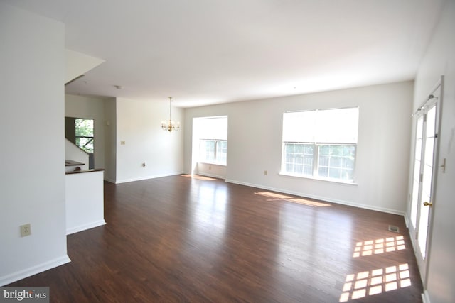 104 Rock Creek Ct, Frederick, MD 21702 - unfurnished living room with a chandelier, dark wood-style floors, and plenty of natural light