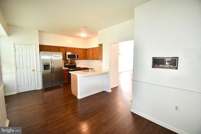 104 Rock Creek Ct, Frederick, MD 21702 - kitchen featuring stainless steel appliances, a peninsula, dark wood finished floors, light countertops, and brown cabinetry