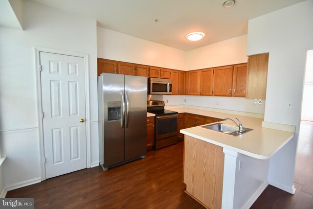 104 Rock Creek Ct, Frederick, MD 21702 - kitchen featuring appliances with stainless steel finishes, brown cabinets, a peninsula, dark wood-style flooring, and light countertops
