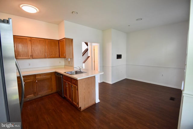 104 Rock Creek Ct, Frederick, MD 21702 - kitchen with a peninsula, stainless steel appliances, dark wood-type flooring, brown cabinets, and light countertops