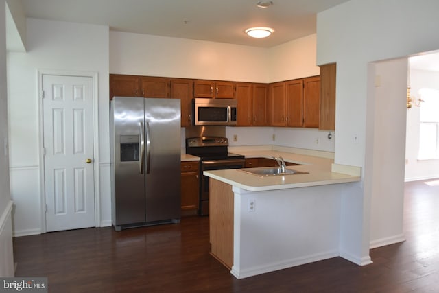 104 Rock Creek Ct, Frederick, MD 21702 - kitchen featuring stainless steel appliances, brown cabinetry, dark wood-style flooring, light countertops, and a peninsula