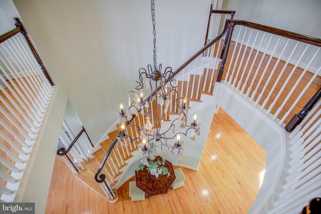 22966 Lois, Brambleton, VA 20148 - stairs with a towering ceiling, wood finished floors, and a chandelier