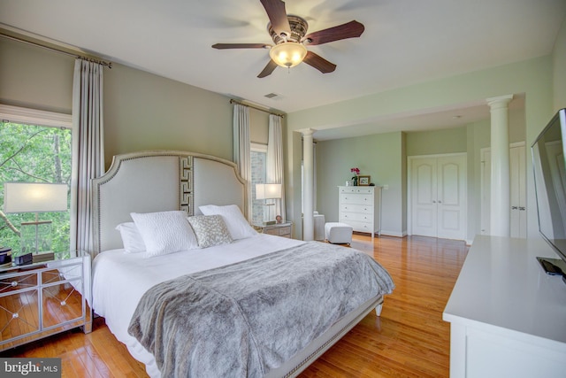 22966 Lois, Brambleton, VA 20148 - bedroom with ornate columns, light wood-style flooring, and a ceiling fan