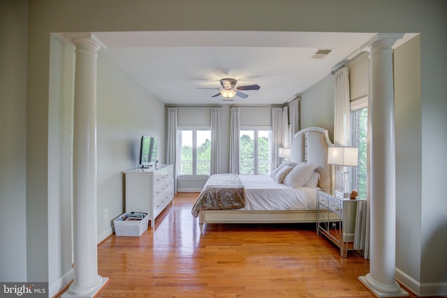 22966 Lois, Brambleton, VA 20148 - bedroom with decorative columns, multiple windows, and light wood finished floors