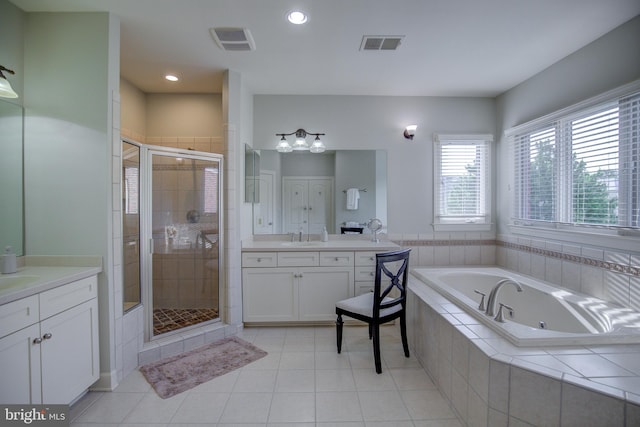 22966 Lois, Brambleton, VA 20148 - bathroom featuring a tub with jets, two vanities, a shower stall, tile patterned flooring, and recessed lighting