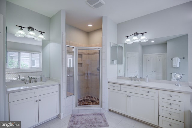 22966 Lois, Brambleton, VA 20148 - bathroom with a shower stall, two vanities, tile patterned flooring, and recessed lighting