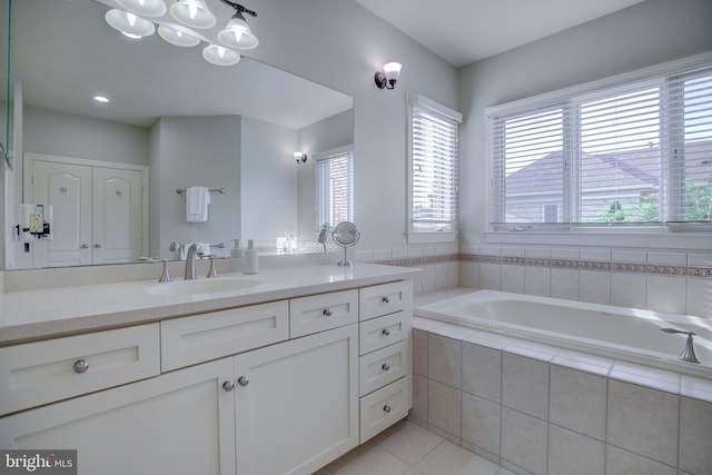 22966 Lois, Brambleton, VA 20148 - bathroom with vanity, a garden tub, and tile patterned flooring