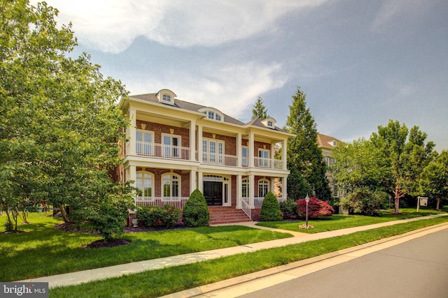 22966 Lois, Brambleton, VA 20148 - view of front facade with brick siding, a porch, a balcony, and a front lawn