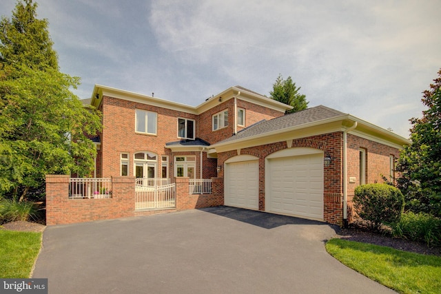 22966 Lois, Brambleton, VA 20148 - view of front of house featuring asphalt driveway, a garage, and brick siding