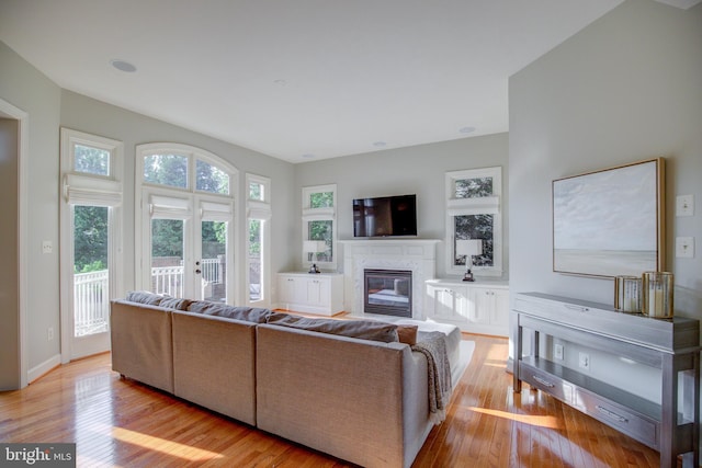 22966 Lois, Brambleton, VA 20148 - living area featuring wood finished floors, a fireplace, and french doors