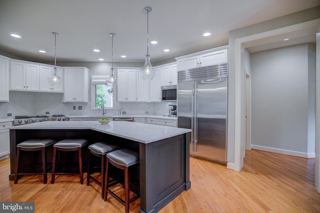 22966 Lois, Brambleton, VA 20148 - kitchen with stainless steel appliances, backsplash, light countertops, light wood-style floors, and recessed lighting