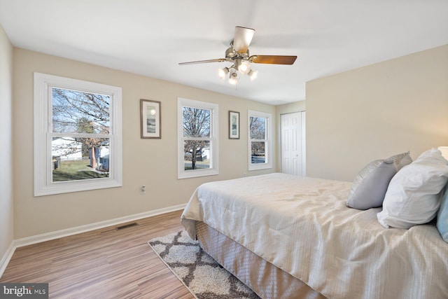 17105 Amity Dr, Derwood, MD 20855 - bedroom with multiple windows, wood finished floors, a closet, and ceiling fan
