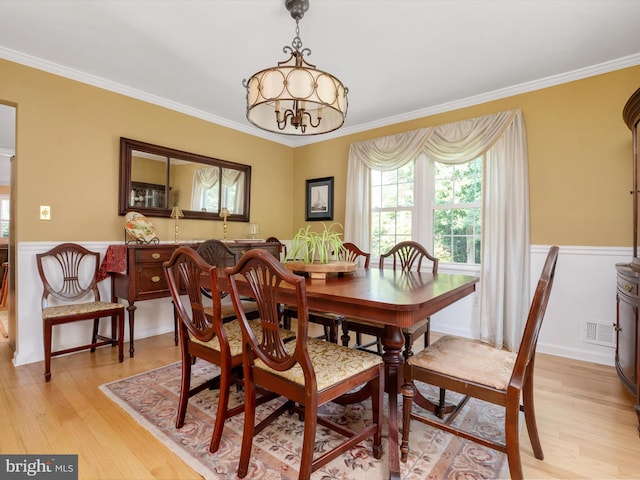 994 Bayberry Dr, Arnold, MD 21012 - dining space with light wood-style floors, ornamental molding, and a wainscoted wall