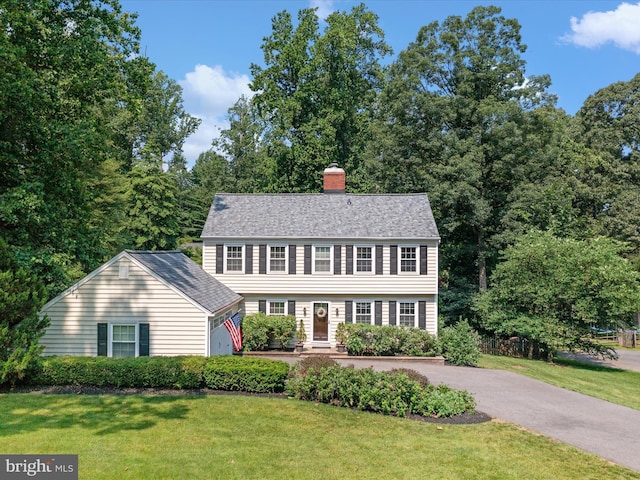994 Bayberry Dr, Arnold, MD 21012 - colonial home featuring a front lawn, a chimney, and asphalt driveway