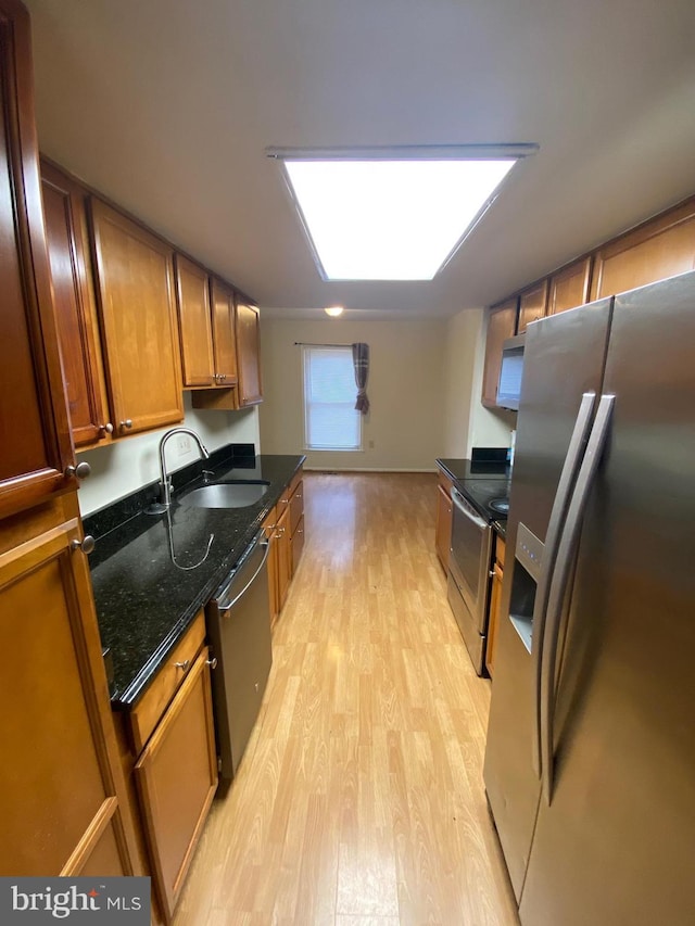 14004 Daleshire Way Unit 49, Burtonsville, MD 20866 - kitchen with appliances with stainless steel finishes, light wood-style flooring, brown cabinetry, and dark stone counters