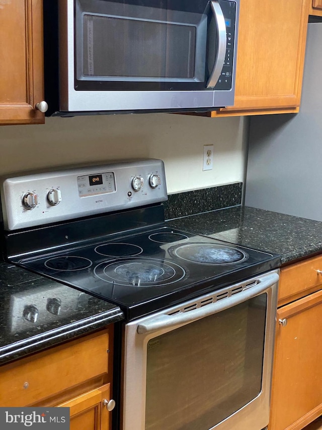 14004 Daleshire Way Unit 49, Burtonsville, MD 20866 - kitchen with appliances with stainless steel finishes, brown cabinetry, and dark stone countertops