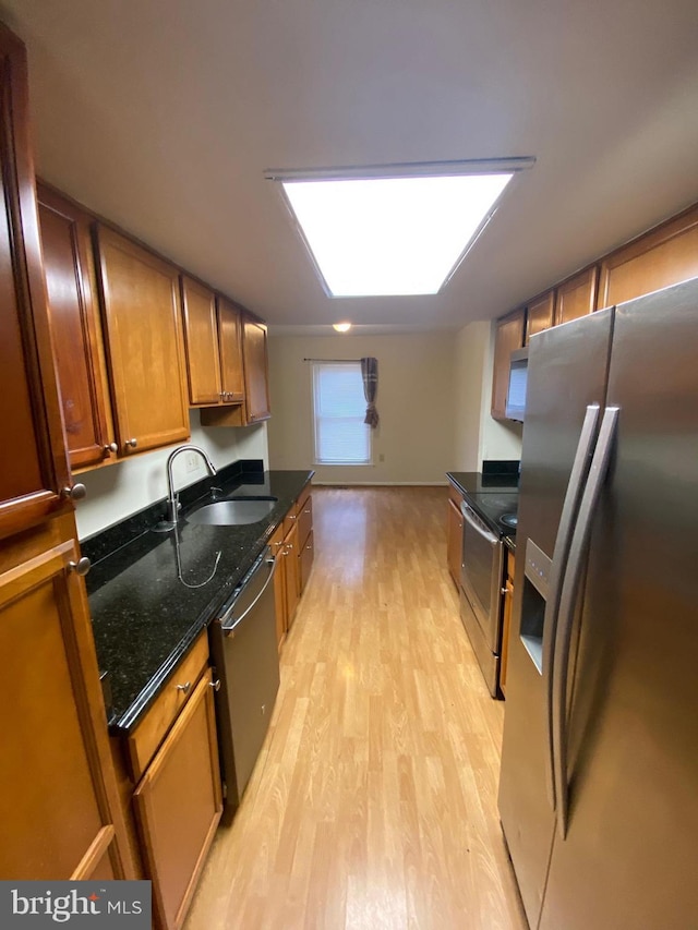 14004 Daleshire Way Unit 49, Burtonsville, MD 20866 - kitchen featuring appliances with stainless steel finishes, light wood-type flooring, brown cabinets, and dark stone countertops