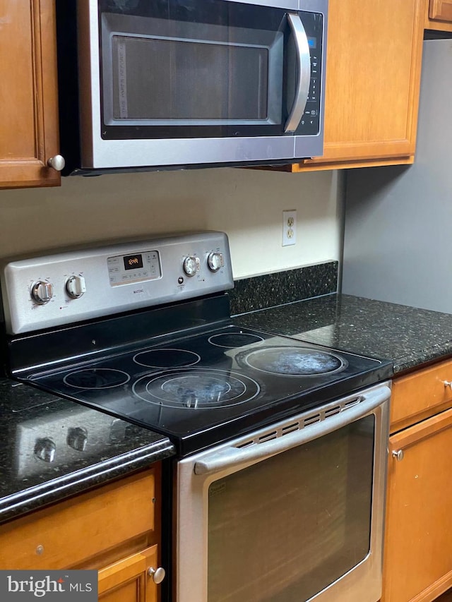 14004 Daleshire Way Unit 49, Burtonsville, MD 20866 - kitchen with appliances with stainless steel finishes, brown cabinets, and dark stone countertops