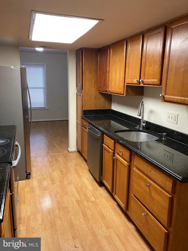 14004 Daleshire Way Unit 49, Burtonsville, MD 20866 - kitchen featuring stainless steel appliances, light wood-style floors, brown cabinets, and dark stone countertops