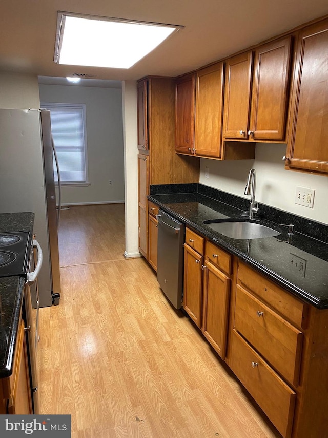 14004 Daleshire Way Unit 49, Burtonsville, MD 20866 - kitchen featuring stainless steel appliances, light wood finished floors, brown cabinetry, and dark stone countertops