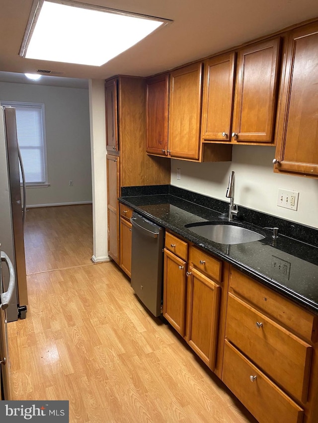 14004 Daleshire Way Unit 49, Burtonsville, MD 20866 - kitchen featuring appliances with stainless steel finishes, light wood-type flooring, brown cabinetry, and dark stone countertops
