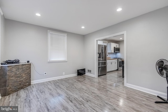 7135 Railway, Dundalk, MD 21222 - unfurnished living room with light wood-style flooring and recessed lighting