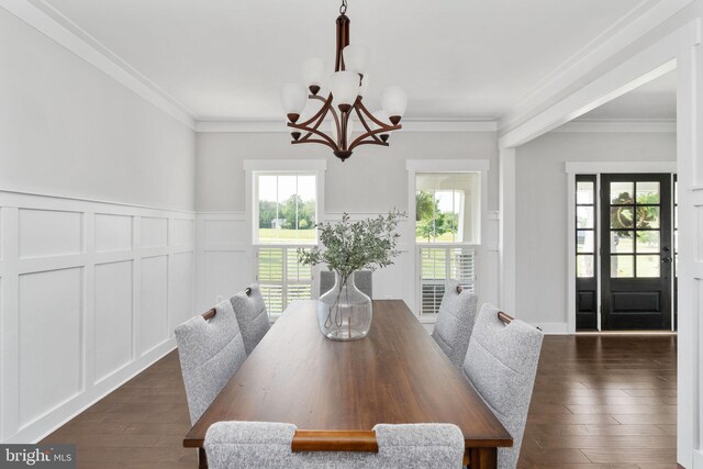 115 Saddle Ridge Ln, Fredericksburg, VA 22406 - dining space with a chandelier, crown molding, a decorative wall, dark wood-type flooring, and a wainscoted wall
