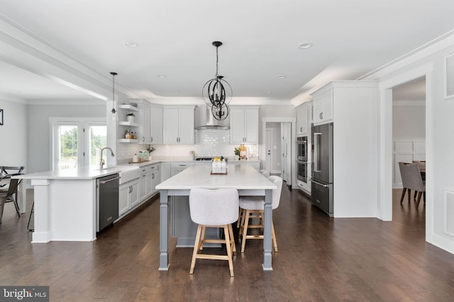 115 Saddle Ridge Ln, Fredericksburg, VA 22406 - kitchen with appliances with stainless steel finishes, a breakfast bar area, a peninsula, open shelves, and light countertops