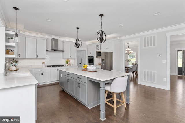 115 Saddle Ridge Ln, Fredericksburg, VA 22406 - kitchen featuring wall chimney exhaust hood, open shelves, appliances with stainless steel finishes, dark wood-type flooring, and a center island