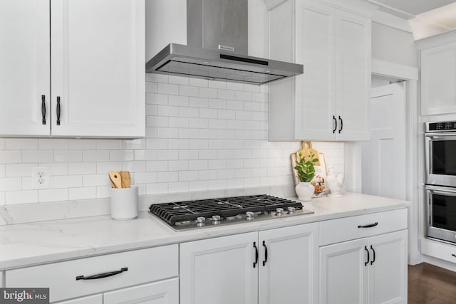 115 Saddle Ridge Ln, Fredericksburg, VA 22406 - kitchen featuring wall chimney range hood, stainless steel appliances, white cabinetry, backsplash, and light stone countertops